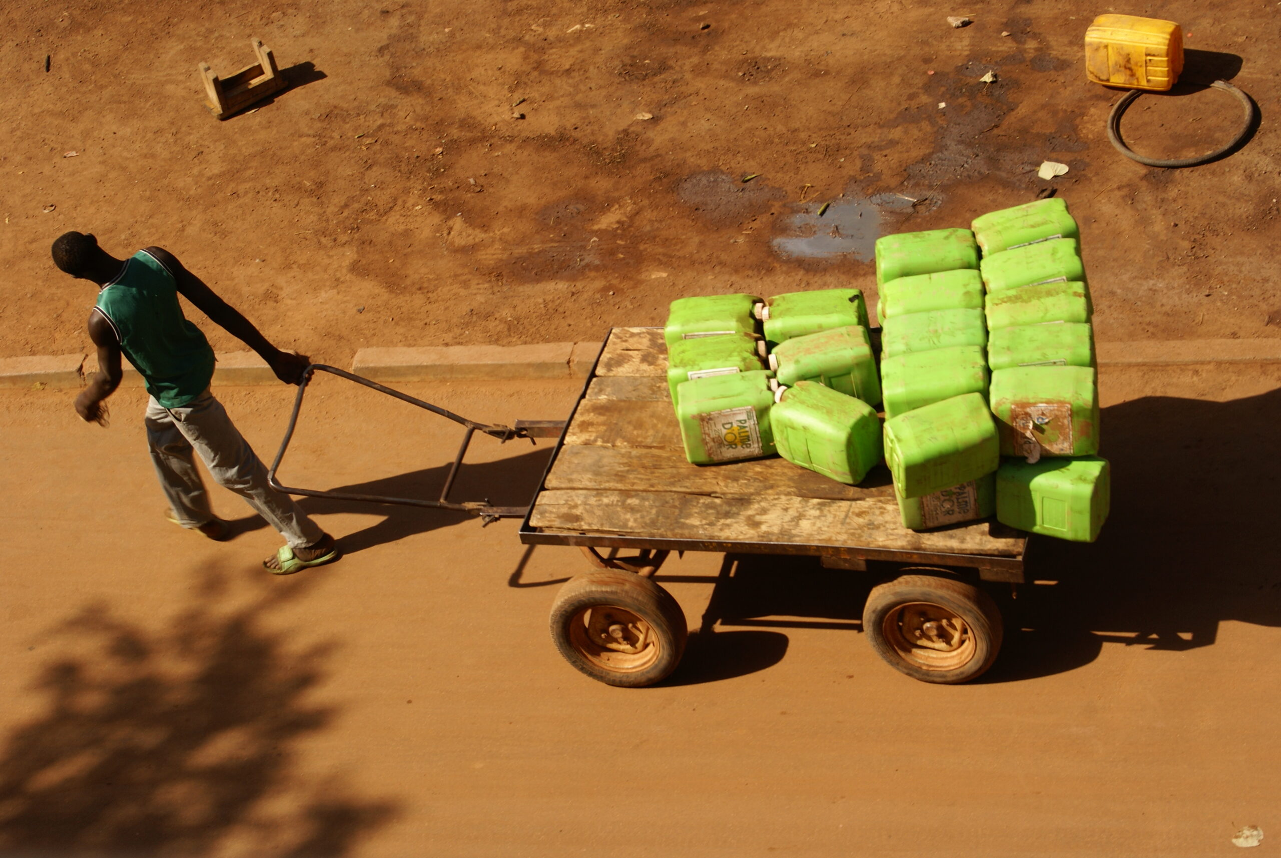 A man drags a trolley of water containers in the street in Ouagadougou, Burkina Faso.