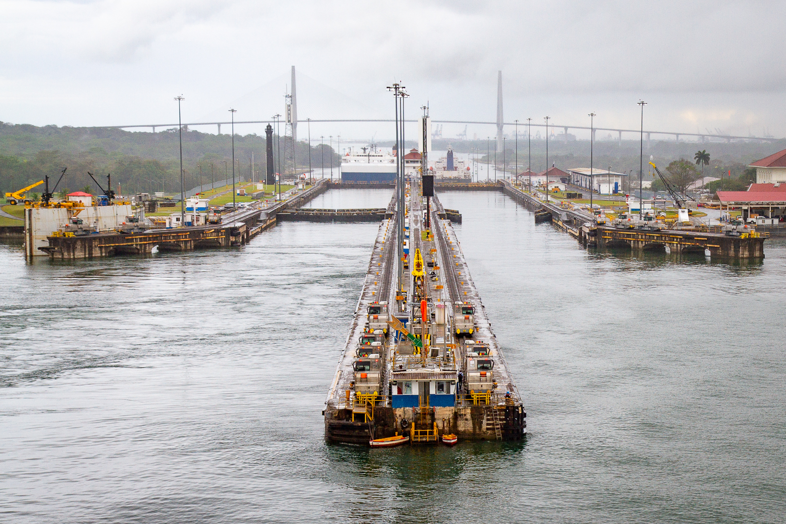A photo of the lock system on the Panama Canal. The Canal is split by a long pier with two seperate locks used for transferring ships up the canal.